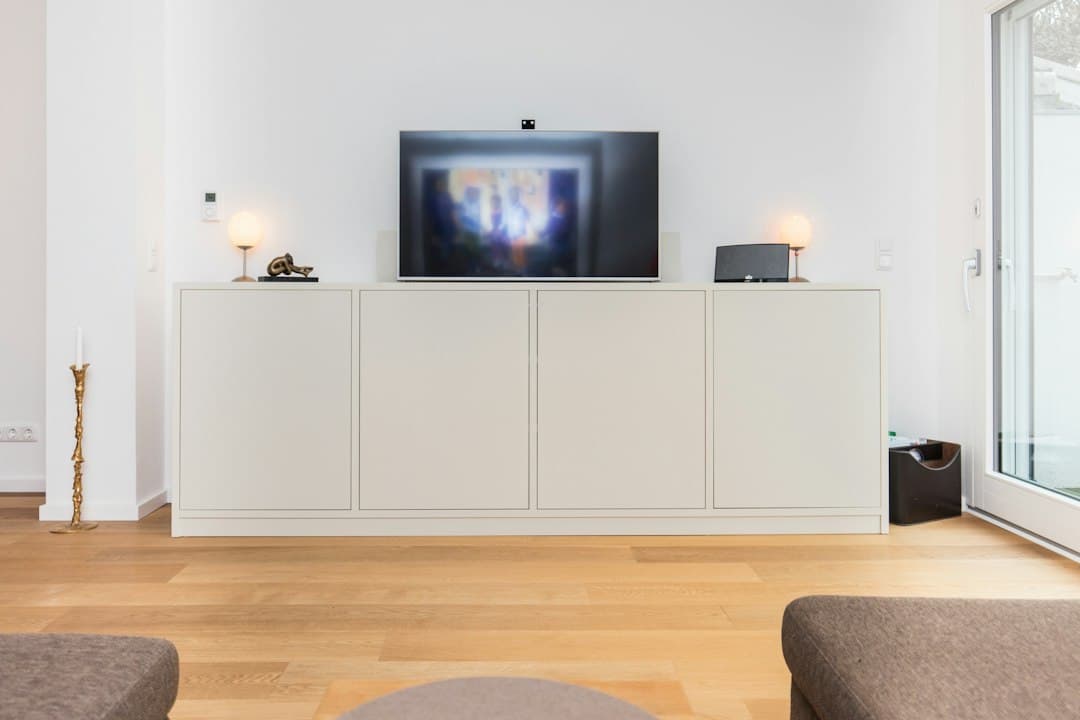 Bright living room with a Smart TV on a white sideboard